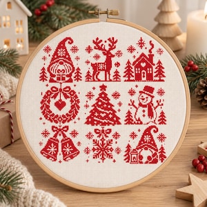 May include: A circular wooden embroidery hoop containing white fabric with a red cross-stitch pattern. The design features nine distinct holiday icons including a gnome, a reindeer, a house, a wreath, a tree, a snowman, bells, a snowflake, and a gnome.