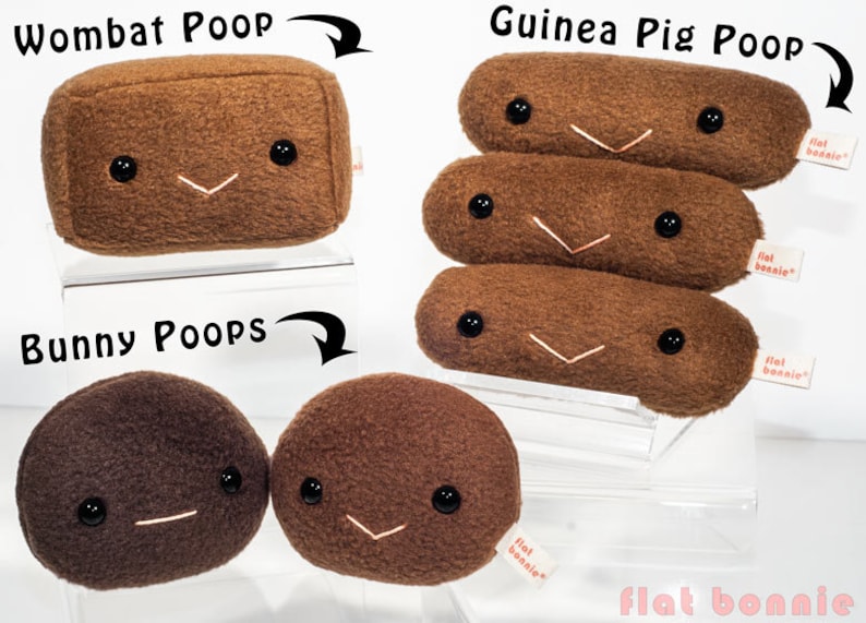 May include: Three plush toys shaped like animal poop. The first is a brown rectangular "Wombat Poop" with a smiling face. The second is a stack of three brown cylindrical "Guinea Pig Poop" with smiling faces. The third is two brown round "Bunny Poops" with smiling faces. All toys have a "flat bonnie" tag.