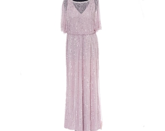 May include: A floor-length dusty pink gown featuring short sleeves and a sheer overlay. The dress is adorned with vertical rows of silver sequins and intricate beadwork, with a V-neckline visible beneath the sheer, embellished upper bodice.
