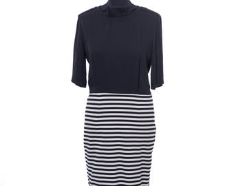 May include: A navy blue dress with a black and white striped skirt. The top of the dress has short sleeves and a high neckline. The skirt is a pencil skirt style with horizontal stripes.
