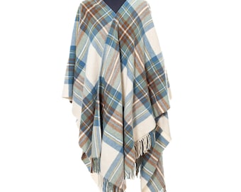 May include: A plaid poncho featuring a pattern of cream, light blue, teal, and brown stripes. The garment has an open front design, a V-neckline, and a hem finished with long, loose fringe detailing along the bottom edges of the fabric.