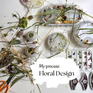 May include: A collection of silicone molds filled with dried flowers, grasses, and botanical elements, alongside orange-handled scissors. A white overlay features the black text: My process: Floral Design, showcasing the craft of resin art.