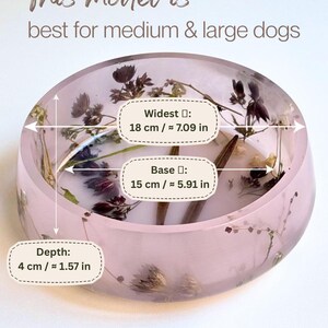 May include: A round, light pink resin pet bowl embedded with dried flowers. Text states: This model is best for medium & large dogs. Widest: 18 cm / 7.09 in, Base: 15 cm / 5.91 in, Depth: 4 cm / 1.57 in. Discover more models in my shop, perfect for small and medium dogs.