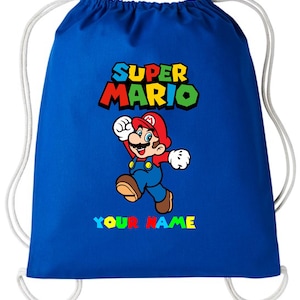 May include: A royal blue drawstring bag with a Super Mario design. The graphic shows Mario with the words "SUPER MARIO" above him in colourful text. Below the character is the text "YOUR NAME" in colourful letters.