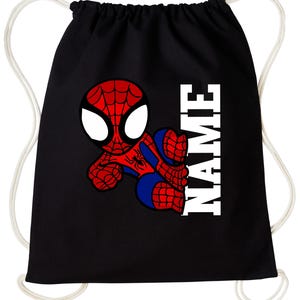 May include: Black drawstring bag with a cartoon Spider-Man design in red, blue, and white. The word "NAME" is printed vertically in white block letters. The bag has white drawstrings.