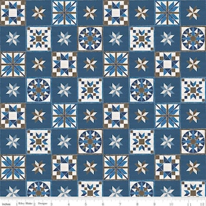 May include: A blue and brown fabric with a repeating pattern of stars, squares, and circles. The fabric is designed for quilting and crafting.
