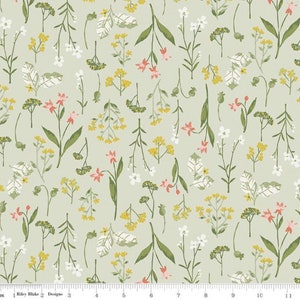 May include: A green fabric with a repeating pattern of small white, yellow, and pink flowers. The flowers are arranged in a random pattern on a light green background.