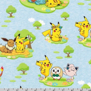May include: Light blue fabric featuring a repeating pattern of various cartoon creatures including yellow Pikachu, brown Eevee, pink Jigglypuff, and round Rowlet in a grassy landscape with trees and flowers. A ruler at the bottom shows 25 cm.