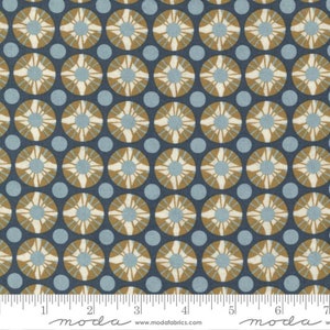 May include: A repeating pattern of blue and brown circles with a white starburst design. The fabric is a cotton blend.