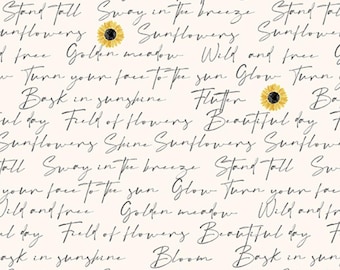 May include: Cream fabric featuring black cursive writing and yellow sunflowers. Phrases such as "Bask in sunshine" and "Field of Flowers" are visible. A ruler is at the bottom.
