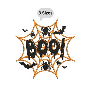 May include: An embroidery design featuring an orange spider web background with the black text BOO! in a dripping font. The design includes black spiders and bats scattered throughout the web. A speech bubble at the top reads 3 Sizes.
