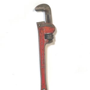 May include: A vintage red and gray pipe wrench, a hand tool with adjustable jaws. The wrench is marked with the number 14, indicating its size in inches. The tool is designed for gripping and turning pipes.