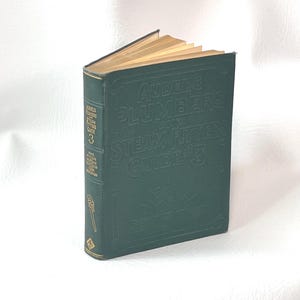 May include: A vintage green hardcover book titled "Audels Plumbers and Steam Fitters Guide 3." The book has gold-colored page edges and embossed lettering. The spine features additional text and a small illustration of a pipe wrench.