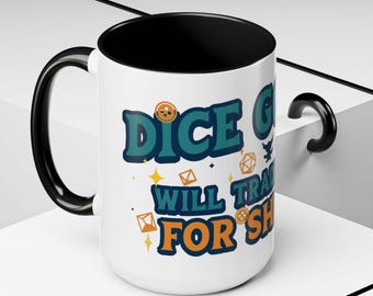 May include: White ceramic mug with a black interior and handle. The mug features the text "DICE GOD WILL TRADE FOR SHINY" in teal and orange, along with dice and star graphics. A fun gift for gamers.