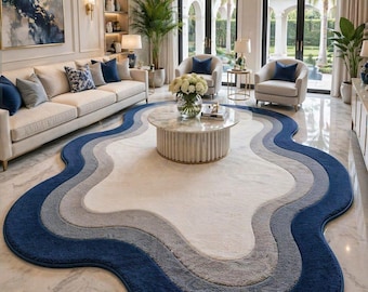 Alfombra de lujo de forma irregular en azul y beige, moderna y abstracta, con borde ondulado, ideal como elemento decorativo para la sala de estar.