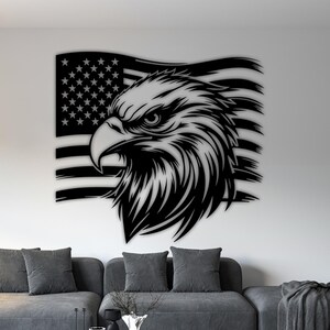 May include: Black metal wall art featuring an eagle's head and the American flag. The eagle is depicted in profile with detailed feathers and a stern gaze. The flag is waving in the background, with stars and stripes.
