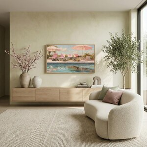 A clean, minimalist living room view featuring a curved white sofa and a tall olive tree in the corner. The funny Palm Springs alligator poolside art stands out on the light green wall, adding a vibrant retro touch to the simple, modern space. The composition highlights the 8K clarity and the fine art texture of the digital download. Elevate your screen’s aesthetic with this sophisticated yet funny animal painting. Click to purchase instantly.