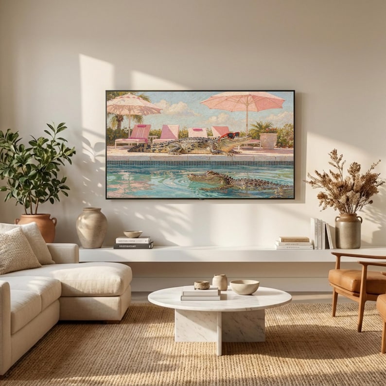 A serene view of a modern minimalist living room where natural morning light illuminates a textured wall. Above a white built-in shelf, the funny crocodile pool art is displayed on a Samsung Frame TV, adding a splash of color to the neutral interior. The scene evokes a sense of calm and high-end coastal living with a touch of whimsical humor. Redefine your technology with this artistic summer background—click to download and enjoy the view.