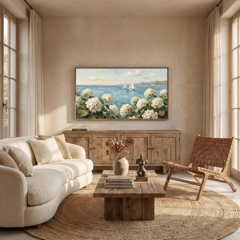 A cheerful, sun-lit living room with a comfortable wicker chair and wooden furniture, creating a classic seaside bungalow atmosphere. The TV art brings the beauty of the outdoors inside, with the sailboats on the water mirroring the bright energy of the space. This is a perfect example of the coastal granddaughter trend in modern home styling. Refresh your beach house decor in seconds with this high-res art—click to buy and download now.