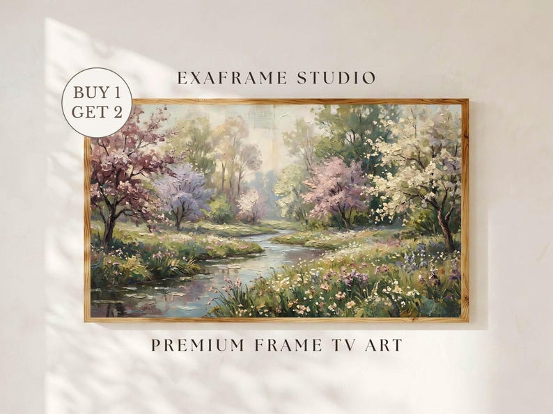 A crisp, sun-drenched minimalist display showing a vintage landscape painting with muted green meadows and spring wildflowers on a premium Samsung Frame TV. Set against a clean neutral cream wall with delicate botanical window shadows, this impressionist nature art brings immediate seasonal charm. Features an attractive buy one get two special promotional offer badge. Elevate your screen decor today—click to download this instant digital art screensaver.