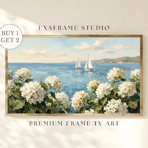May include: A framed landscape painting featuring a serene seascape with two sailboats on a blue ocean. White hydrangea flowers frame the bottom of the painting. The text "EXAFRAME STUDIO" and "PREMIUM FRAME TV ART" are visible.