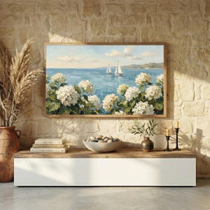 A sleek coastal noir-inspired living space with a white floating console and a rustic stone accent wall. The vibrant sailboats and lush white flowers on the TV screen provide a soft, organic contrast to the architectural lines of the room. This setup highlights the human premium feel of the oil painting's visible brushstrokes against modern technology. Give your smart TV a high-end makeover with this coastal art—get your files instantly.