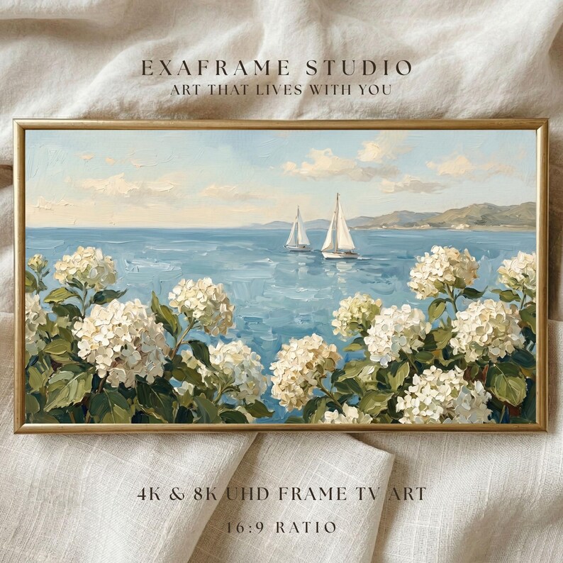 A professional 16:9 ratio display of the Nantucket seaside art, shown in a bright and modern home setting. The horizontal composition of sailboats and hydrangeas perfectly fits the Samsung Frame TV screen, creating a seamless window to the ocean. The balanced colors of "Cloud Dancer" white and "Cool Blue" add a restorative energy to the room's atmosphere. Bring the airy optimism of summer to your screen—click to download instantly.