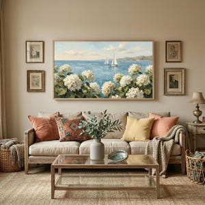 A warm and inviting living room featuring the Nantucket hydrangea TV art against a textured wall. Decorative pillows in earthy tones and ceramic vases create a curated, lived-in feel that pairs perfectly with the grandmillennial art style. The scene showcases the artwork as a centerpiece of social curation and home comfort. Elevate your daily view with this stunning Mediterranean sea landscape—download your files and enjoy the view.