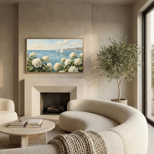 A luxurious living room scene with a contemporary curved sofa and a classic fireplace. Above the mantel, the Samsung Frame TV displays the serene Nantucket seaside painting, acting as a high-end statement piece. The soft lighting and high-quality textures in the room emphasize the old money decor vibe of the sailboats and hydrangeas. Transform your television into a portal to the ocean—purchase this digital masterpiece and save today.
