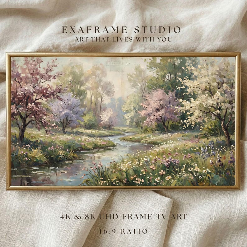 A delicate vintage landscape painting featuring muted green meadows and spring wildflowers displayed inside a sleek wood frame resting on a textured linen textile background. The impressionist brushstrokes and soft natural color palette evoke a tranquil pastoral atmosphere. Perfectly optimized for smart displays, this digital file brings timeless heritage charm to modern interiors. Click to download this high-resolution art screensaver instantly.