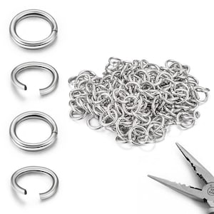 May include: A collection of silver-colored metal jump rings, including four individual rings shown in a vertical column and a larger pile of interconnected rings, accompanied by a pair of metal needle-nose pliers in the bottom right corner.