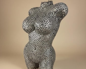 A torso sculpture made from steel nuts is a custom steel statue on a stand