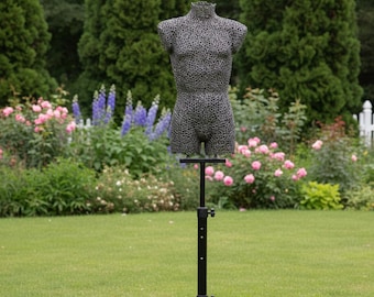 Floor sculpture of a male torso, a welded miniature made of nuts, gray steel color