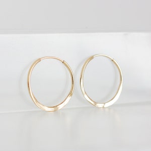 A pair of gold hoops with a hammered finish