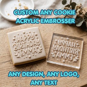 May include: A square cookie with the words "Happy Birthday Emma" embossed on it, next to a clear acrylic embosser. The text "CUSTOM ANY COOKIE ACRYLIC EMBOSSER" and "ANY DESIGN, ANY LOGO, ANY TEXT" are also visible.