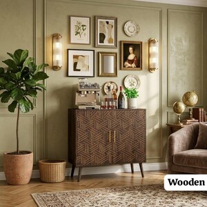 May include: A dark brown wooden cabinet with a geometric pattern on its two doors, featuring thin gold vertical handles and tapered legs. The cabinet is positioned against a sage green wall decorated with framed art, wall sconces, and globes.