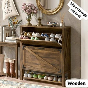 May include: A wooden shoe storage cabinet with a dark brown finish, featuring a tilt-out compartment with multiple pairs of shoes and a lower open shelf. The cabinet has a diagonal brace design on the front panel and black metal hardware accents.