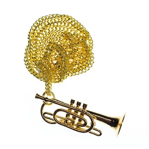 May include: A gold chain necklace with a gold trumpet pendant. The chain is a curb style and the trumpet is a miniature replica.
