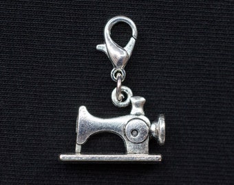 May include: Silver charm in the shape of a vintage sewing machine with a silver lobster clasp.