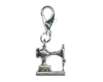 May include: Silver charm in the shape of a vintage sewing machine with a silver lobster clasp.