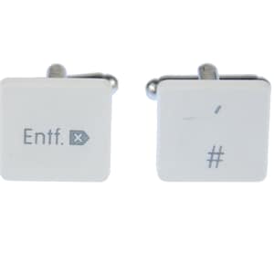 May include: A pair of white cufflinks shaped like computer keys. One cufflink has the text "Entf." and a small "X" symbol. The other cufflink has a "#" symbol.