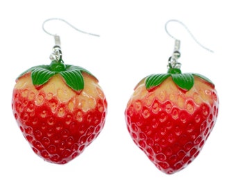 May include: A pair of red and yellow strawberry earrings with green leaves and silver hooks.