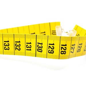 May include: A yellow measuring tape with black numbers, starting at 125 and ending at 134.