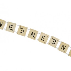 May include: A bracelet made of wooden tiles with the letters "N, E, E, N, E, E, N, E" spelled out.