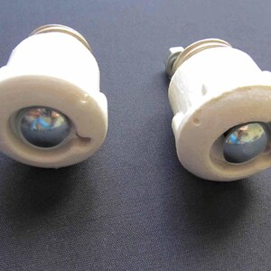 May include: Two white ceramic roller skate wheels with metal ball bearings. The wheels are designed for inline skates.