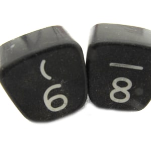 May include: Two black plastic dice with white numbers. The first die shows the number 6 and the second die shows the number 8.
