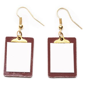 May include: A pair of gold clip-on earrings with a brown clipboard design. The clipboards have a white paper insert.