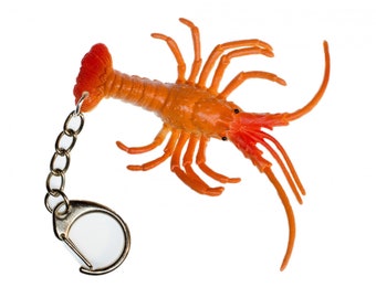 May include: Orange and red lobster keychain with a silver chain and ring.
