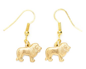 May include: A pair of gold-tone dangle earrings featuring a lion charm. The earrings have a hook closure.
