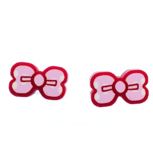 May include: A pair of pink bow-shaped earrings with white polka dots and a red outline.